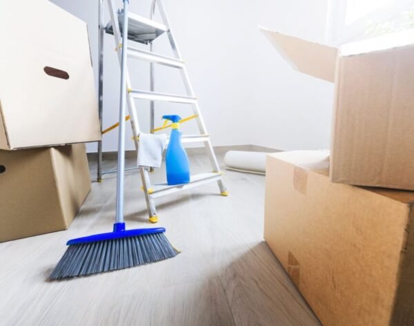 Empty room full of cardboard boxes and cleaning things for moving into a new home